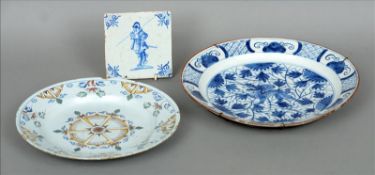 An 18th century Delft blue and white plate The centre decorated with a dragon; together with an 18th