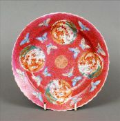 A Chinese porcelain medallion dish Decorated with four dragon roundels interspersed with butterflies
