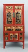 A late 19th/early 20th century Chinese cabinet The panelled twin cupboard doors decorated with