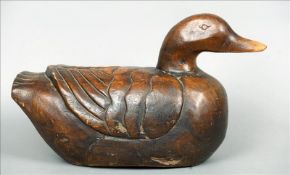 A large carved wooden model of a duck Naturalistically modelled. 46 cms wide. Some scuffing,