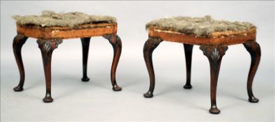 A pair of mid 18th century mahogany stools Each with shell carved cabriole legs standing on pad