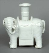 A 19th century Chinese blanc de chine spill vase Formed as an elephant. 17 cms wide. Some