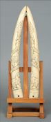 A pair of 19th century ivory tusk carvings Carved in the round with various animals, including a