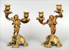 A pair of 19th century French patinated bronze figural candelabra Modelled respectively as a boy and