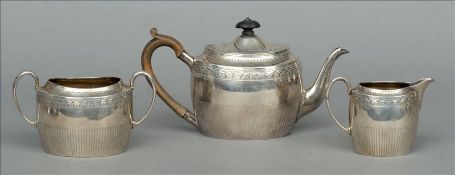A Victorian three piece silver tea set, hallmarked London 1882, maker’s mark of JA JS Comprising: