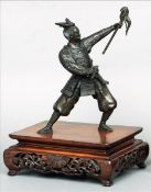 A Japanese Meiji period patinated bronze model of a Samurai warrior Standing in the kosei no kamae