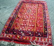 A kilim long rug The crimson red field with four bands of stylized tree decoration, deep blue and