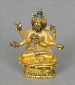 A fine 19th century Sino-Tibetan hand tooled gilt copper miniature figure of a deity Typically