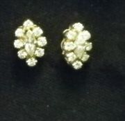 A pair of 18 ct gold diamond set ear studs The marquise cut central stone enclosed by eight