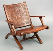 An unusual early 20th century leather covered folding deckchair The leather panels with Aztec