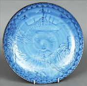 An Oriental blue ground plate The brown rim bordering a lakeland scene with mountains in the