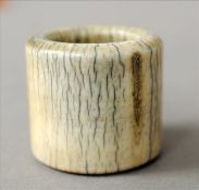 A Chinese ivory archers ring The plain band of typical form. 2.75 cms high. Natural crazing,