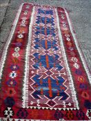 A kilim runner Woven in the Van design, the abrashed pink/brown main field with repeating design