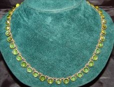 An 18 ct gold Old cut peridot set drop necklace and a pair of peridot set drop earrings The former