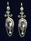 A pair of Edwardian unmarked yellow metal amethyst and seed pearl drop earrings Each 5.5 cms high.