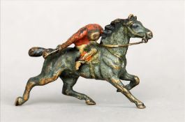 A 19th century cold painted bronze model Formed as a horse with huntsman up. 5.5 cms wide. Some