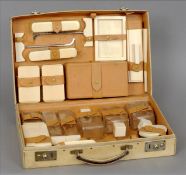 An Art Deco vanity set The vellum case enclosing various ivory and ivory mounted fittings. 43 cms