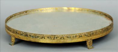 A 19th century gilt bronze mounted mirrored dumb waiter The circular mirror plate bordered by a