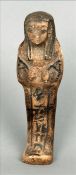 An Egyptian pottery shabti Of typical form with painted decoration. 14.5 cms high. Surface wear,