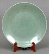 A large Chinese porcelain celadon crackle glazed charger 46 cms diameter. Generally in good