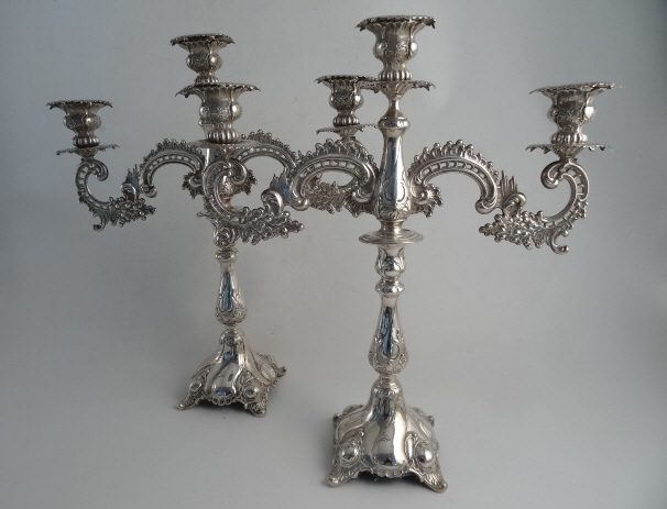 A PAIR OF M & S SILVER TABLE CANDELABRA, 800 standard. The rococo C-scroll and leaf design two