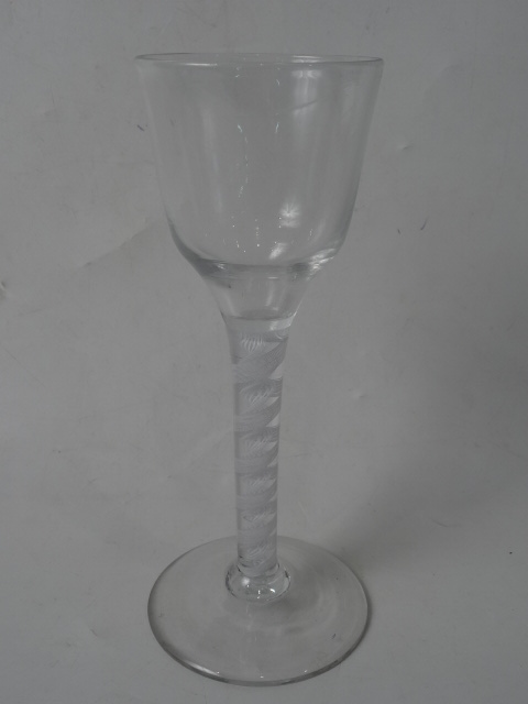 AN 18THC OPAQUE DOUBLE TWIST  OGEE BOWL WINE GLASS on conical foot.   17.7cm