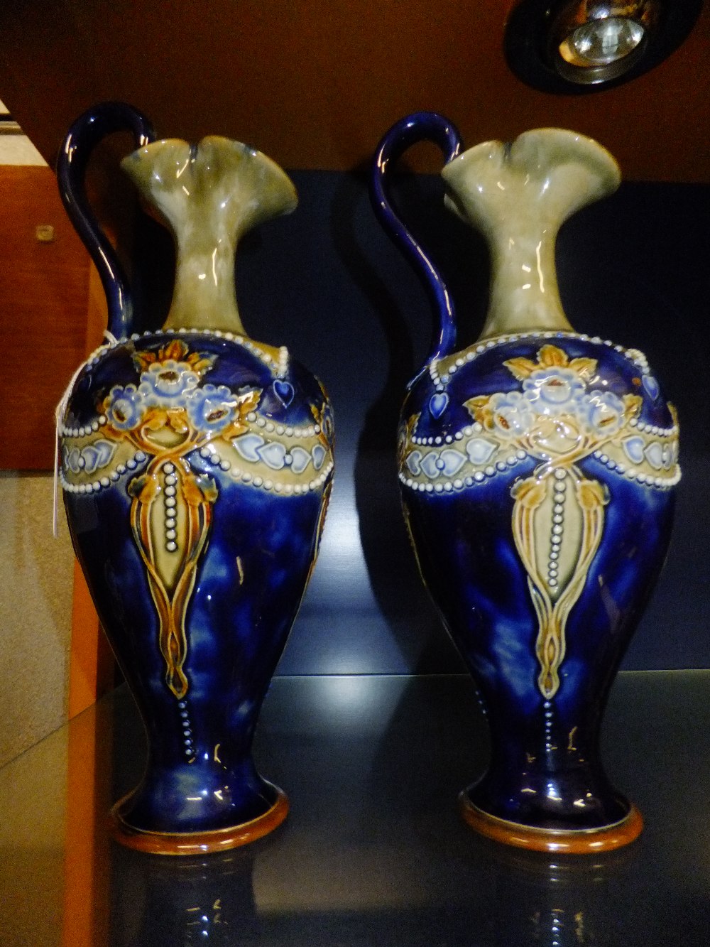 A pair of good quality C1910 Royal Doulton urn shaped jugs having floral decoration, signature to