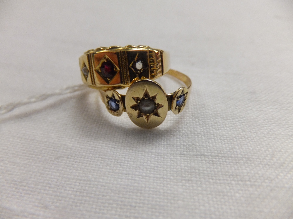 A 15ct gold ring inset with central ruby flanked by diamonds, size K and a 15ct gold ring inset with