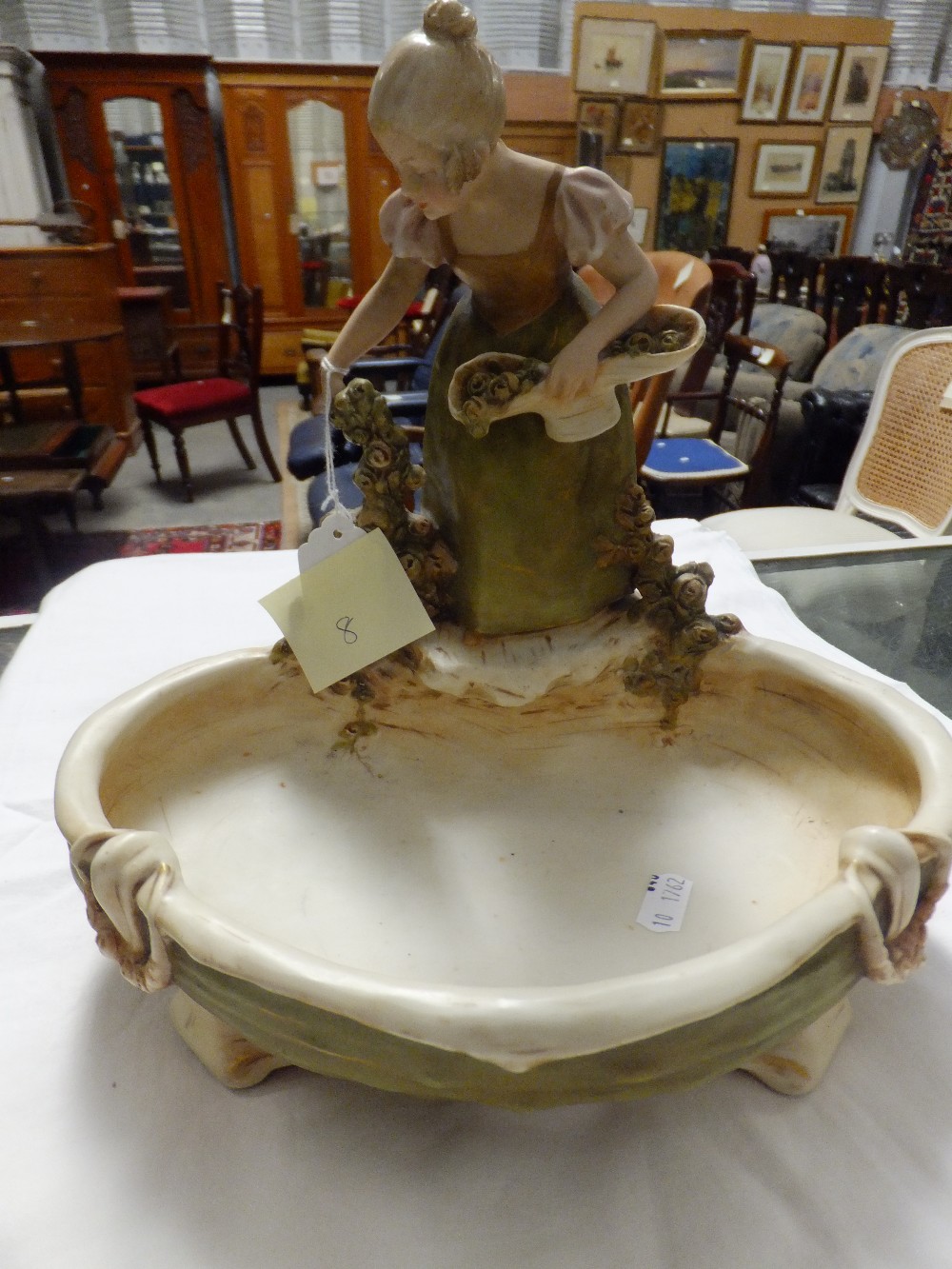 A Royal Dux table centre piece depicting a young girl with flowers