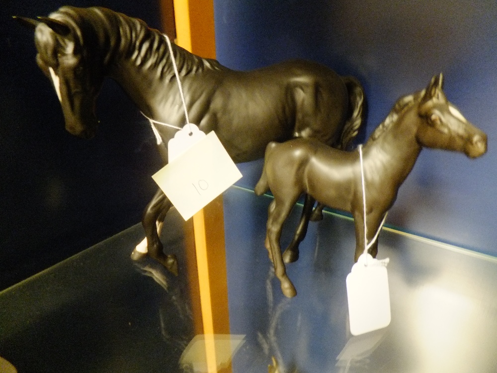 A Beswick black beauty stallion and a foal figure