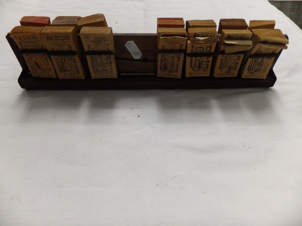 A quantity of through fare bus tickets in wooden stand