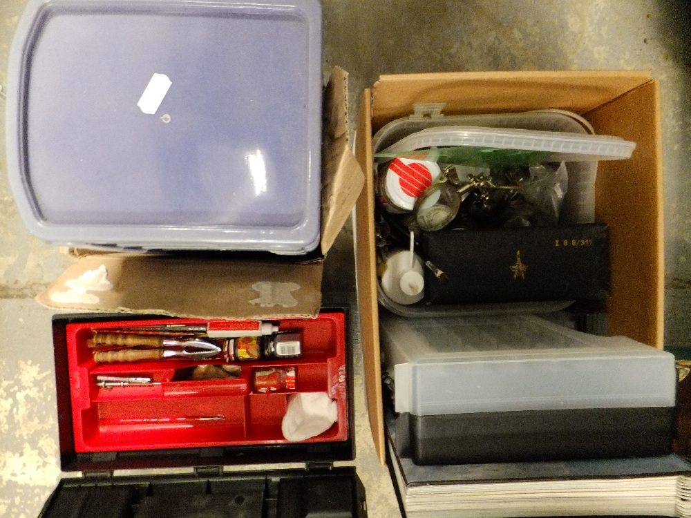 A selection of model making equipment in three boxes to include stands, brushes, paints and