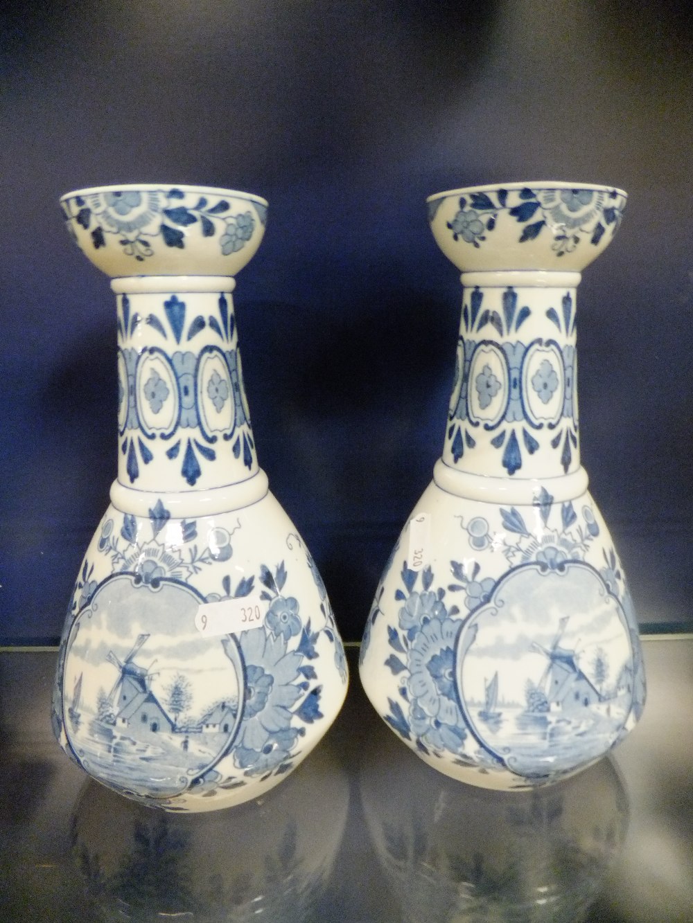 A pair of Delft hand-painted blue & white vases, having pictorial panels of windmill's on the