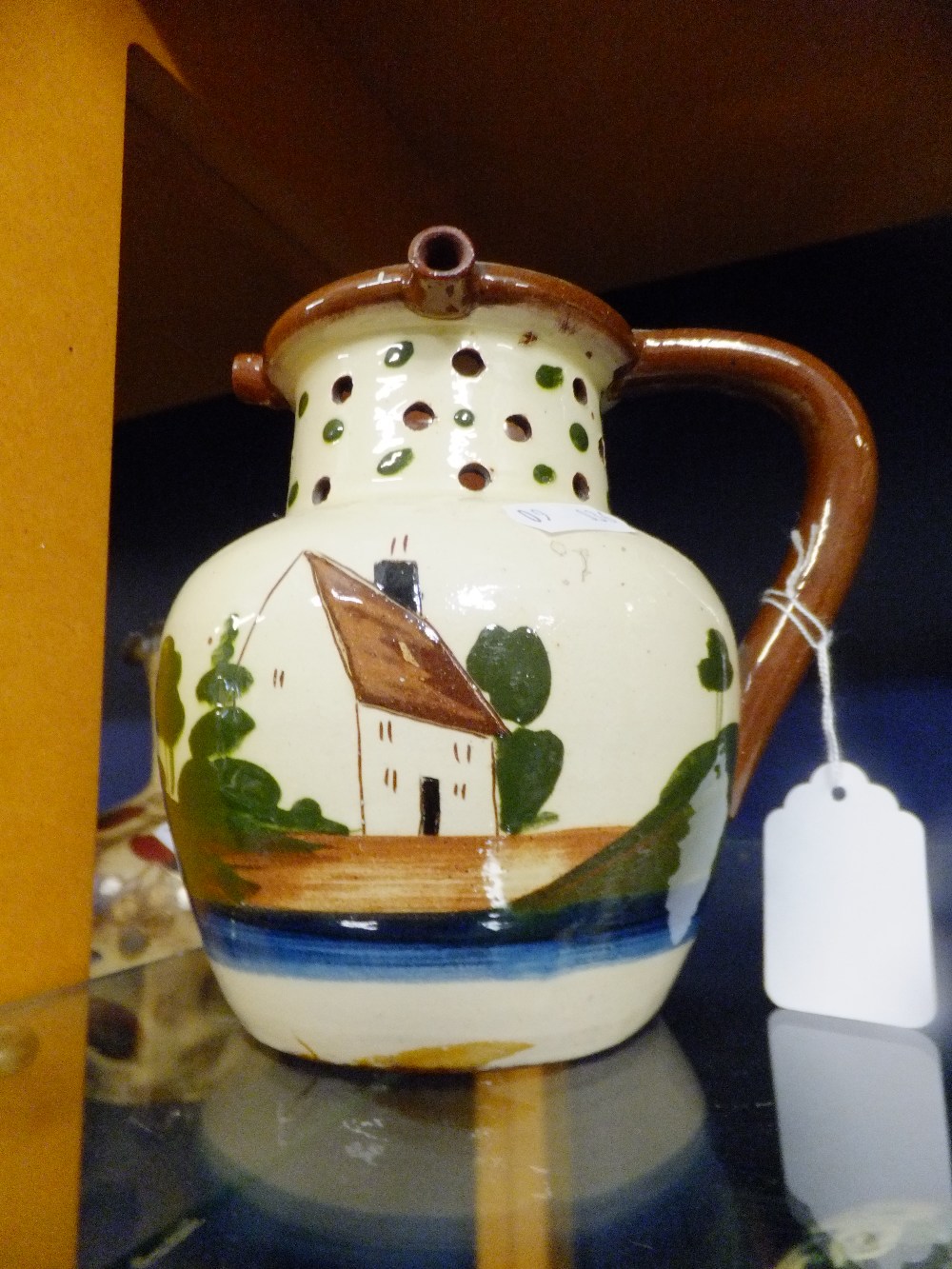 A Torquay pottery motto-ware puzzle jug