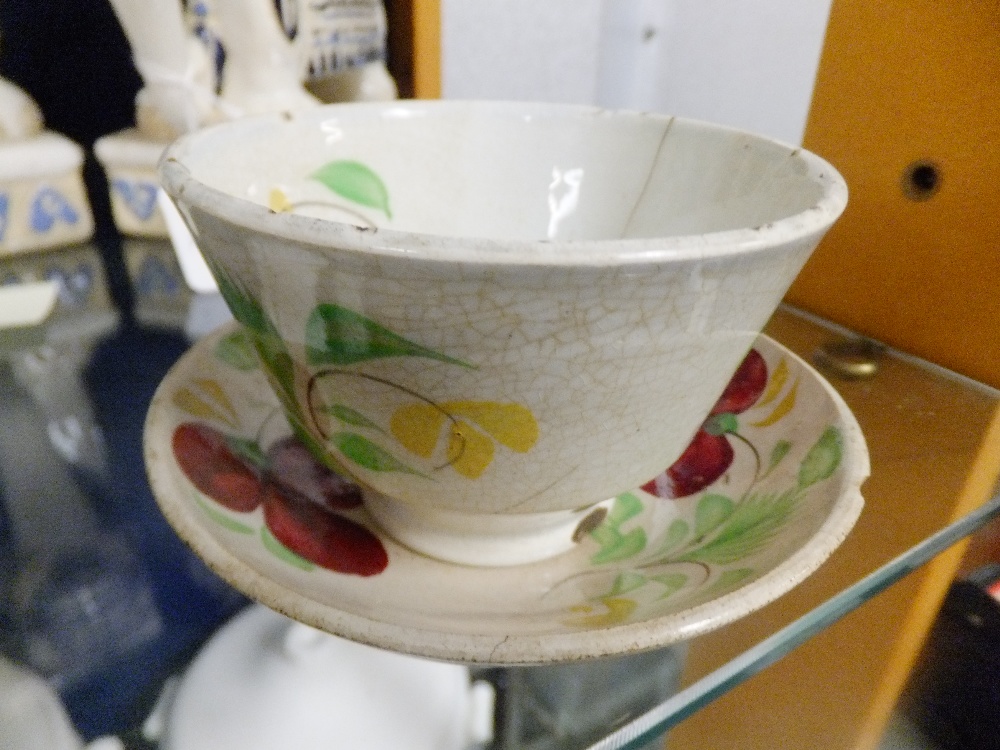 An early 19th C hand-painted tea bowl and saucer