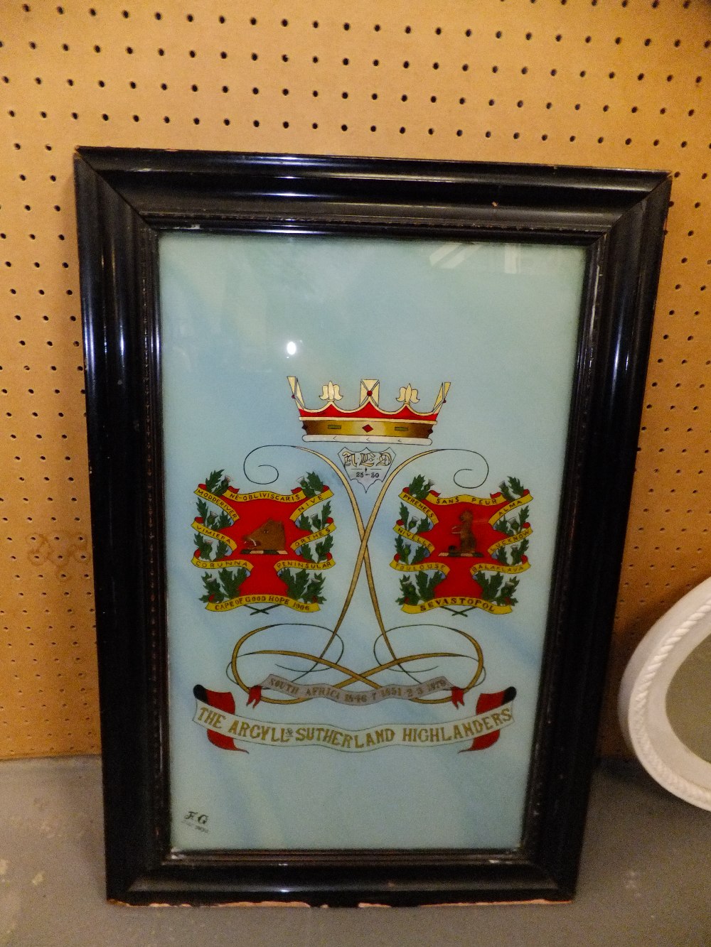 A 1930's hand painted Sutherland and Argyle Highlanders picture on glass, framed