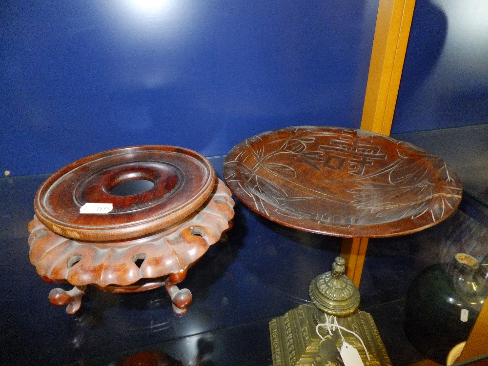 A carved oriental stand and a wooden bowl