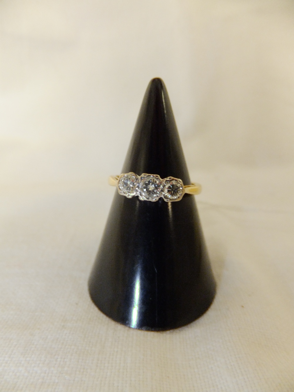 An 18ct gold three stone diamond ring, size H