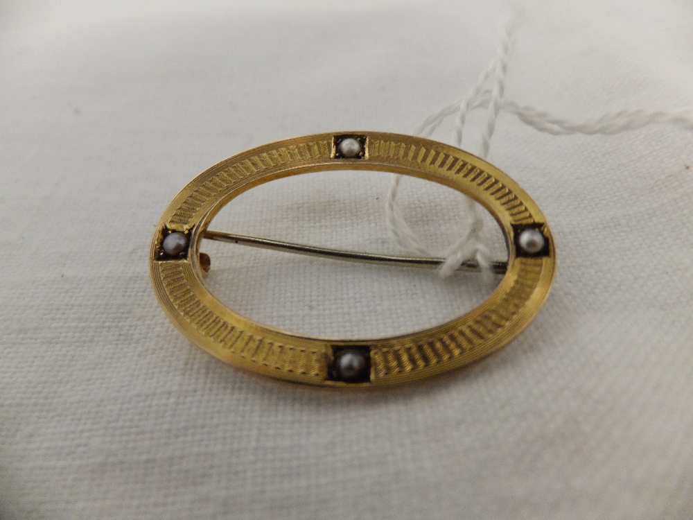 A 14k gold brooch with seed pearls and inscription to back