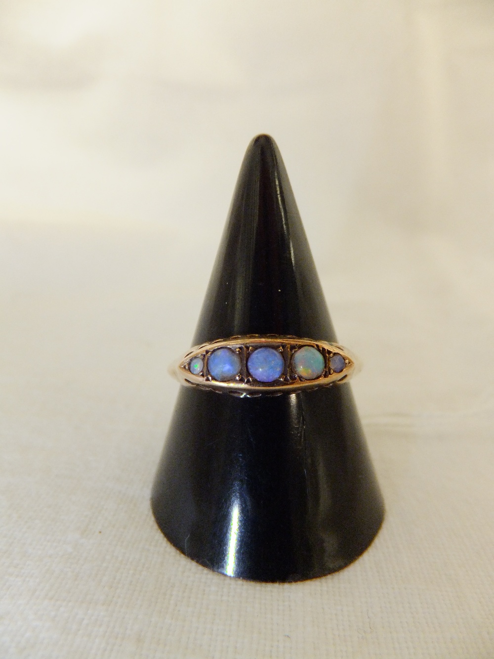 A 9ct gold five stone opal ring, size R