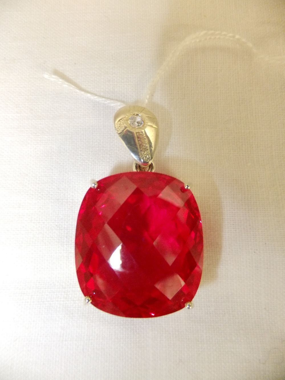 A silver set pendant having large red topaz stone