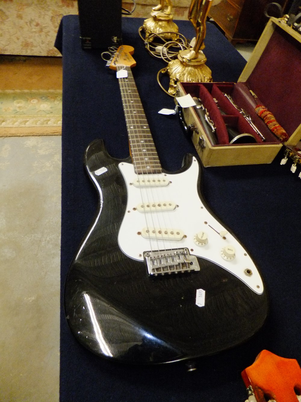 A Fender Squier 'Bullet' electric guitar having black gloss finish and a B.B. Blaster 10 watt