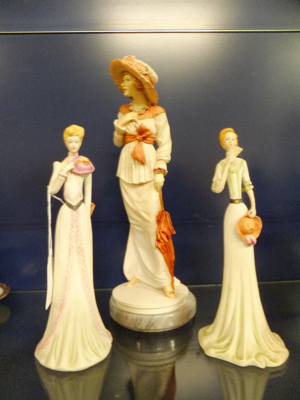 A Classique by Royal Doulton 'Vanessa' figurine and two Portuguese figurines