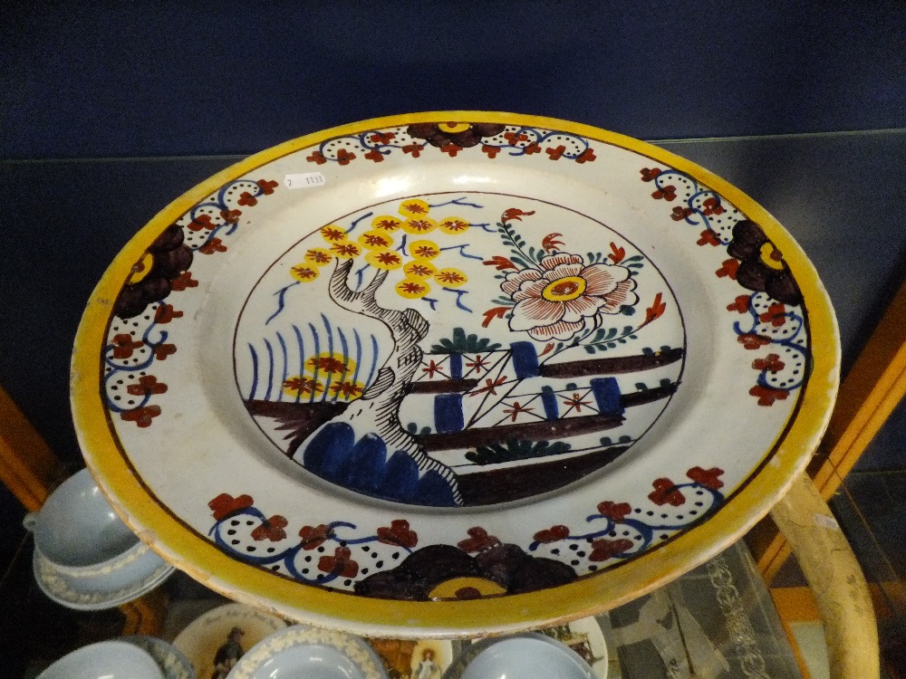 A late 18th/ 19th C Delft charger having floral border with pictorial panel to centre 13.5" diameter