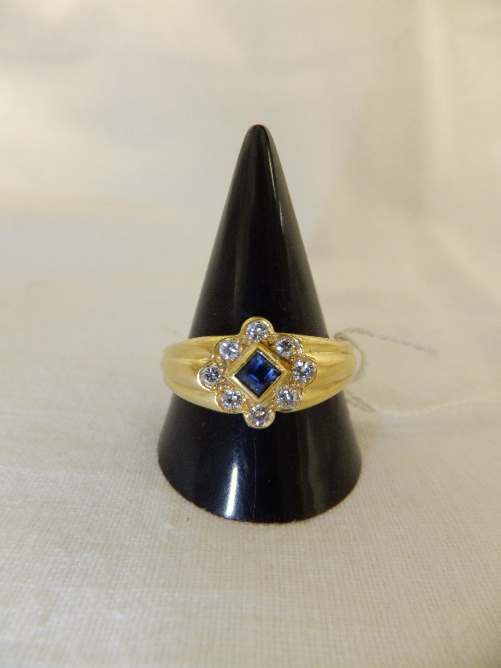 An 18ct gold diamond and sapphire ring, size V