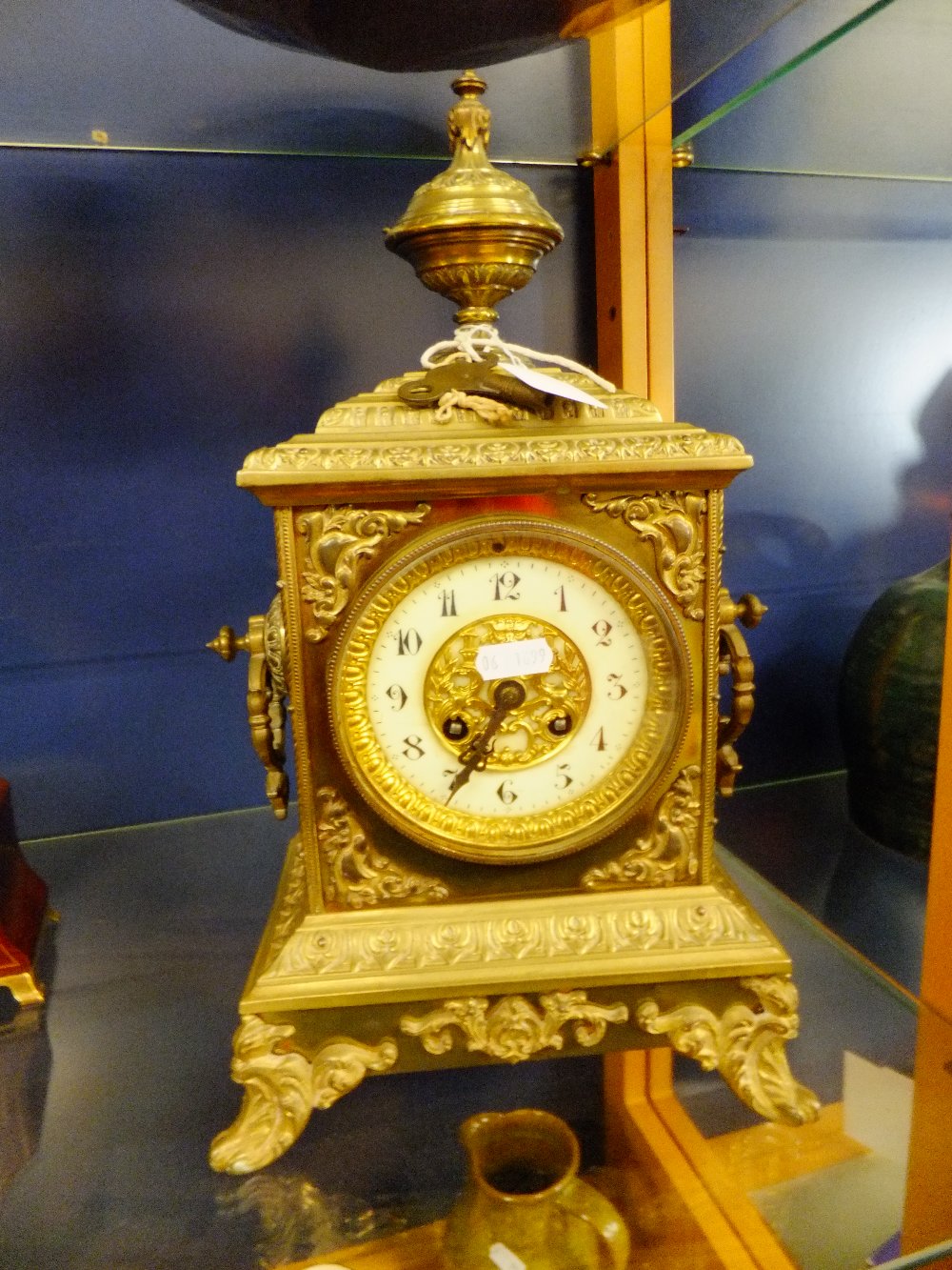 An ornate brass mantle clock having enamel and brass dial, eight day Jappy Freres movement