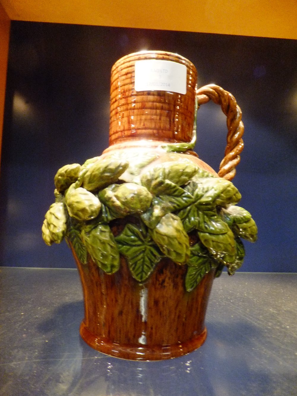 A C1890's Rye Hop Pottery water ewer with applied hops and vines to body, with rope twist handle (