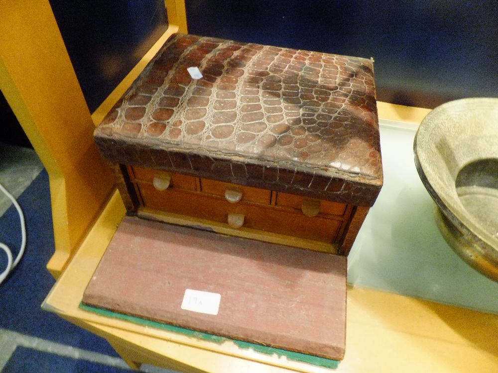 A crocodile skin jewellery box in need of restoration