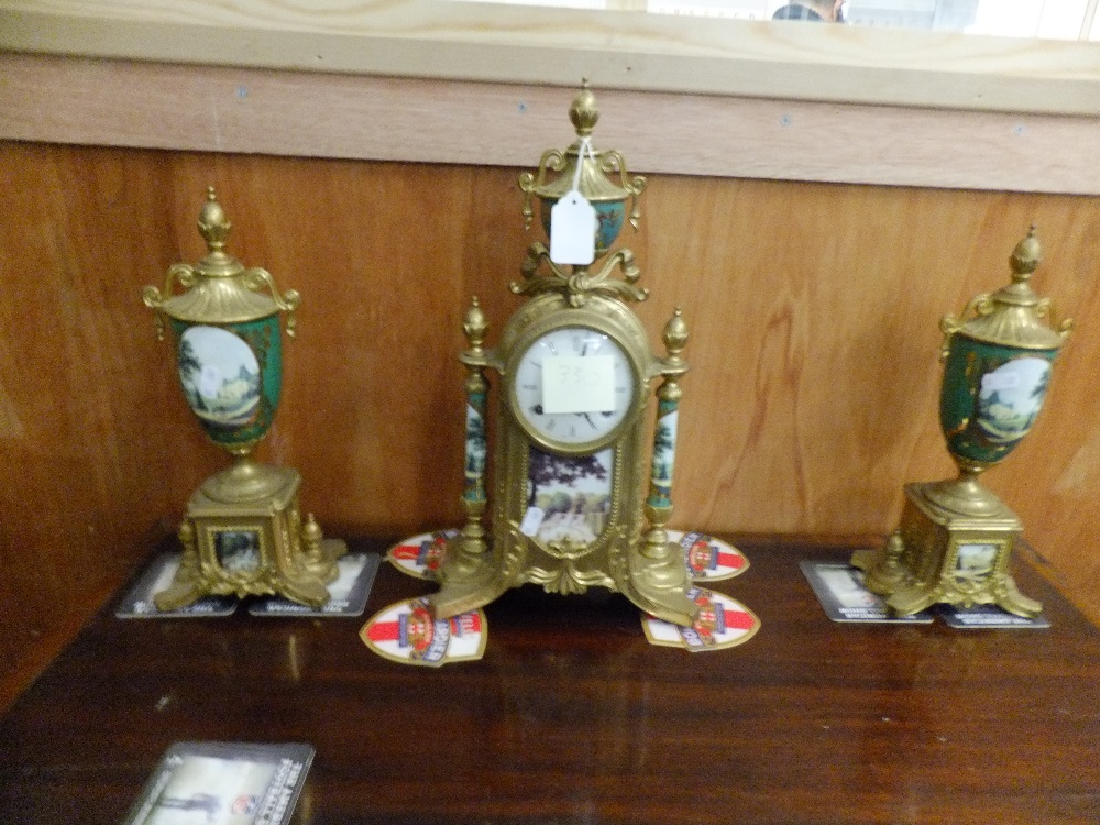 A reproduction gilt brass and porcelain garniture clock set