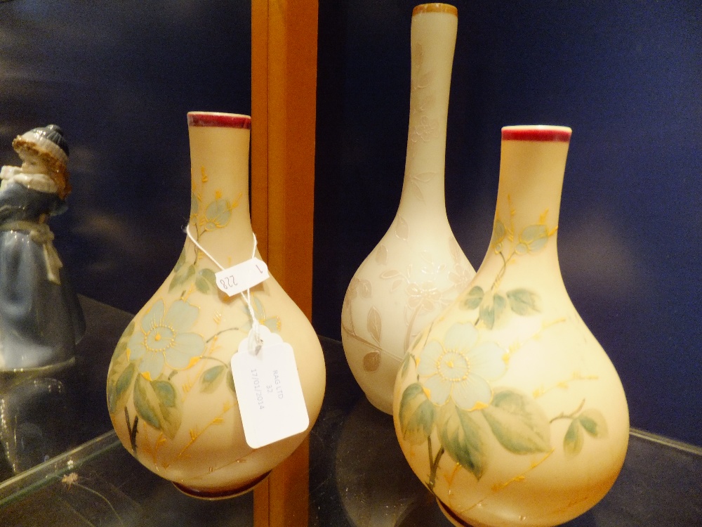 A pair of opaline glass vases with floral decoration and another